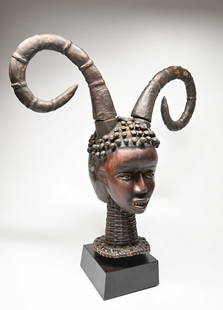 A Janus Ekoi Dance Crest with Spiral Horns: A very finely carved wood janus faced dance crest with tightly wrapped untanned antelope skin adhered to the mask, carved dreadlock like hair and two fantastic curling horns. Ekoi or Ejagham peoples,