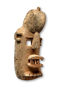 A Dogon Hunter Mask: A highly stylized carved wooden mask with weathered surface heavily patinated with inset wooden teeth. The Mask was worn by a man of the AWA society, acting as an aggressive Hunter during dancers