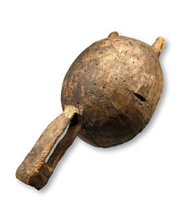 A Bamana Kono Shrine Mask: A carved wooden mask form with well worn and weathered surface and with evidence of shrine use, areas where rodents have chewed the wood likely after ritual offerings were poured onto the mask. The