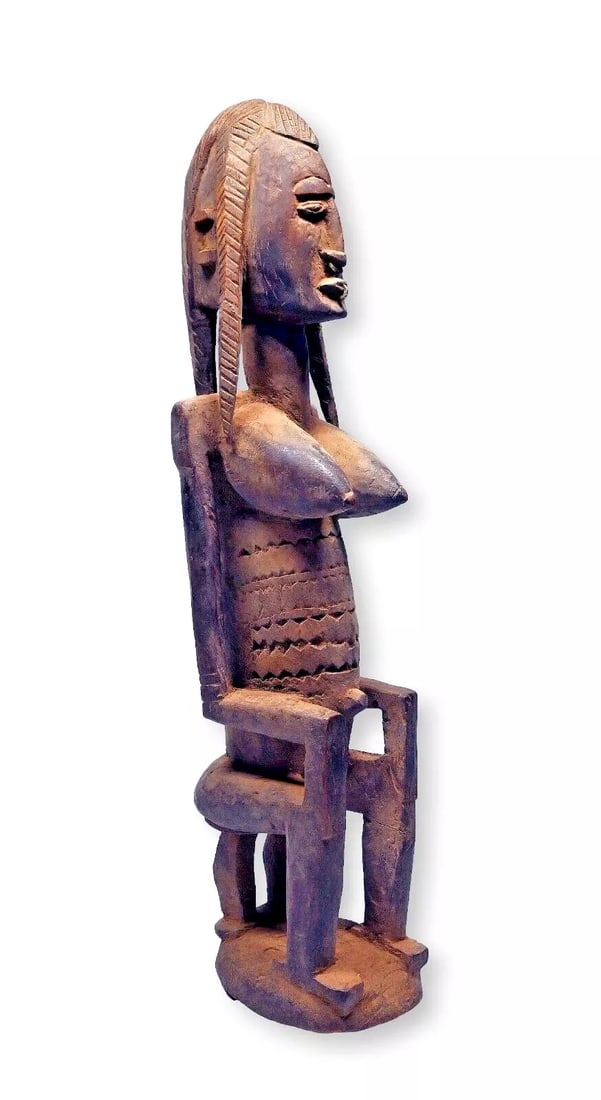 A Dogon Seno Plains Sculpture of a Female Ancestor: A well weathered and worn older female ancestor sculpture from the Seno plains region of Dogon country, Dogon peoples, Mali, West Africa. This unique Seno style is quite desirable among collectors.The