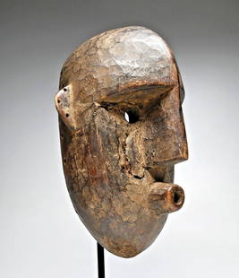 A Bamana African mask: A highly stylized carved wooden dance mask with a heavily weathered and eroded surfaceBamana peoples, Mali, West Africa. The sculpture measures 12 x 7.5 inches. There is no display stand included.
