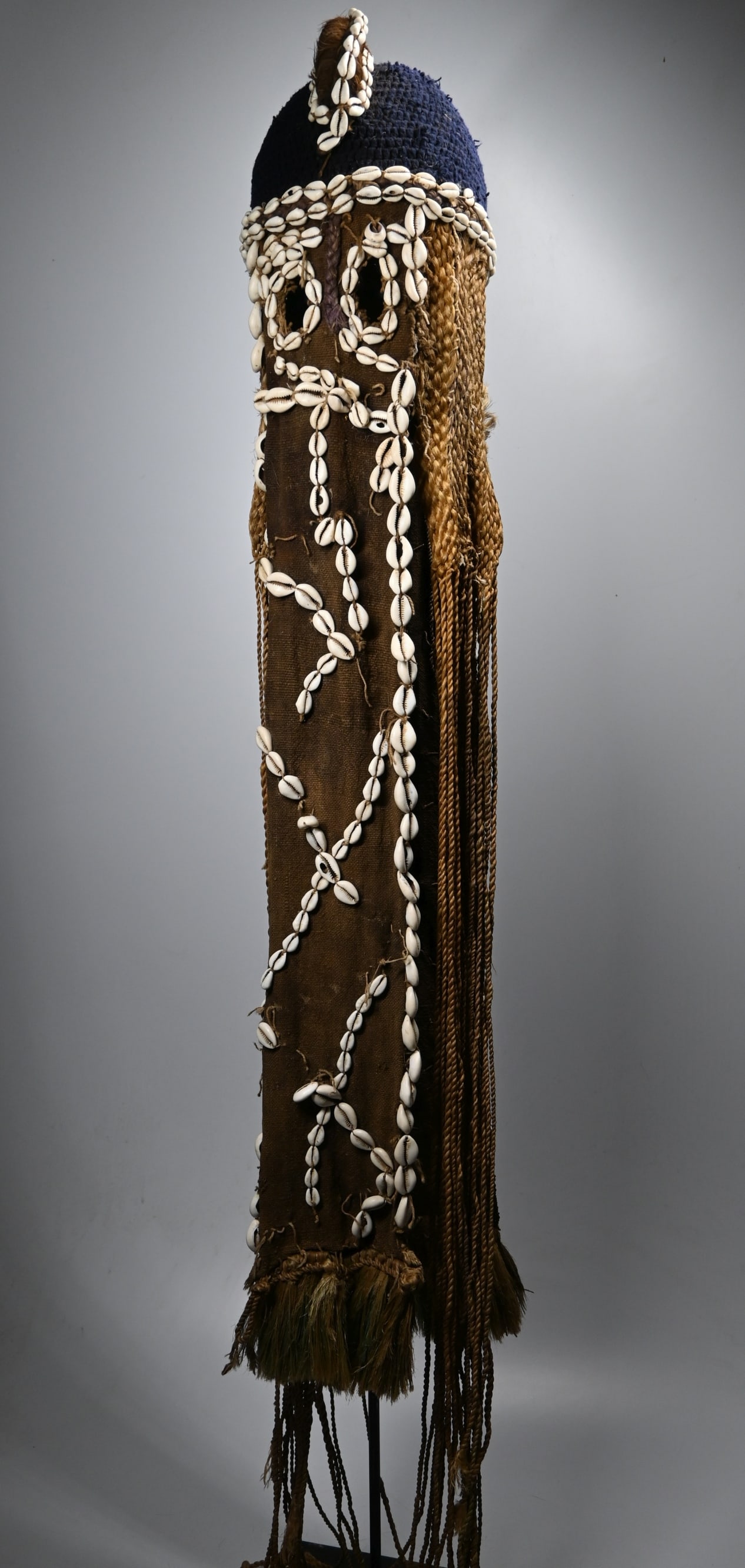 A Dogon Bede Fiber Headdress: A Long ceremonial headdress and costume known as BEDE , and often worn by dancers and stilt walkers to represent the women of the Fulbe ethnic group who were considered beautiful, but marriage was not