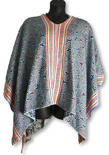 A White Shipibo Embroidered Ponhco, Amazon Indian: This is a hand embroidered and dyed cotton textile poncho with a hood from the Peruvian Amazon jungle, South America. The Shipibo peoples weave such textiles for ceremonial use during Ayahuasca