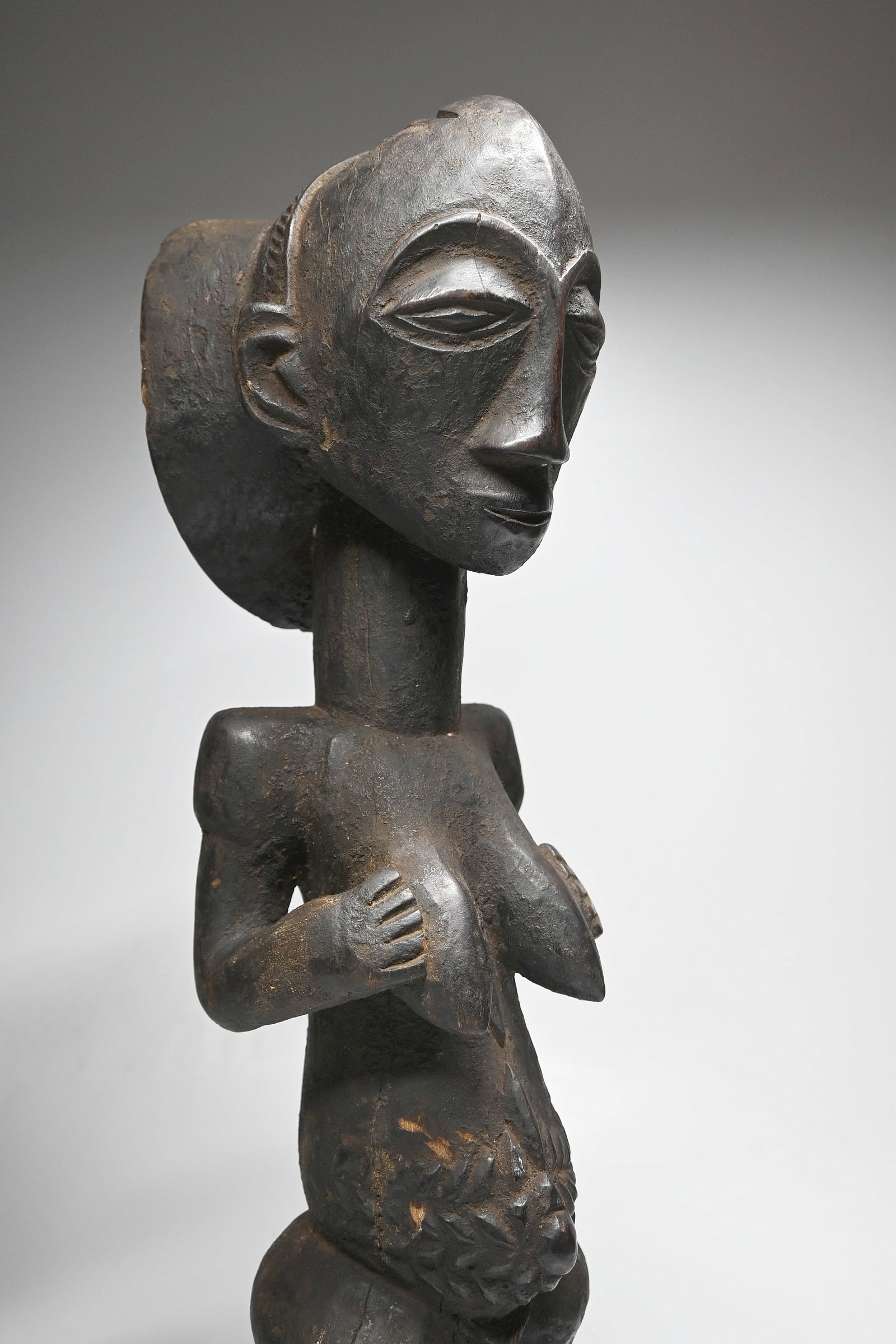 A Hemba Female Sculpture: This is a carved wooden commemorative sculpture of a female important ancestor from the Hemba peoples, of the DRC/ Congo, central Africa. This sculpture was carved from a very heavy dense wood with si