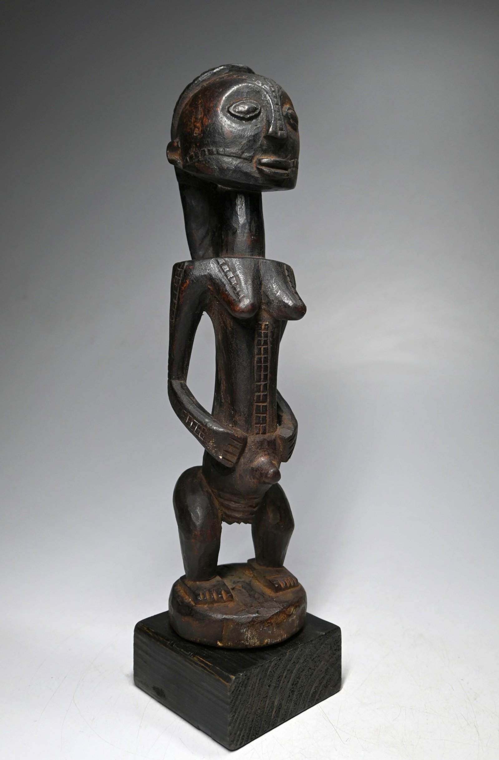A Tabwa Female Sculpture: This is a carved wooden commemorative sculpture of a female important ancestor from the Tabwa peoples, of the DRC/ Congo, central Africa. This sculpture is carved wood with signs of wear and appears t
