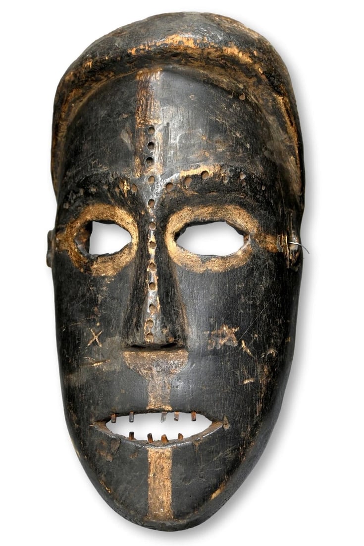 A Ngbaka African mask: A Carved wooden mask with inset wooden teeth, painted with kaolin clay pigments. Bakongo peoples, DRC/ Congo, Africa. The mask measures 12 inches tall x 6.5 inches wide. *There is no display stand inc