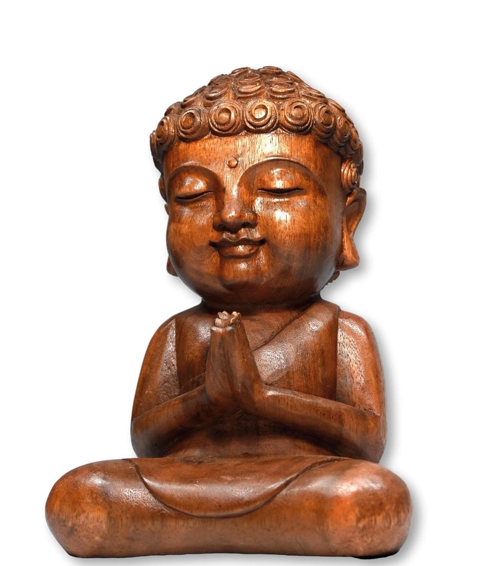 A Serene Carved Buddha from Indonesia: Hand Carved Wooden Buddha From Bali.This is a serene and beautiful hand carved wooden ( dense suar wood) Buddha from Tegallelan Village in Bali Indonesia. The sculpture measures 12.75 x 7 inches wide.