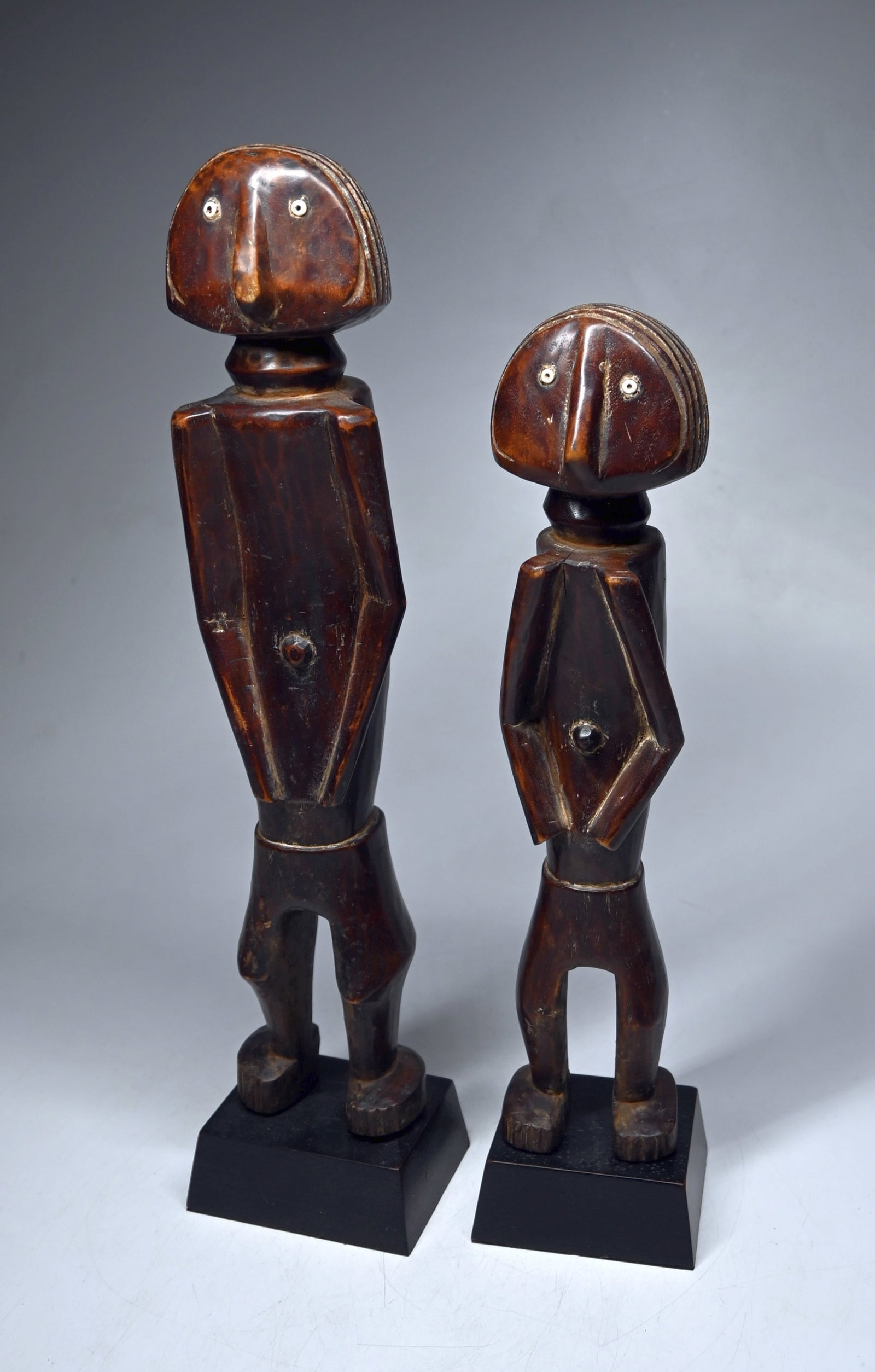 A Pair of Ngbaka or Azande sculpture: A pair of carved wooden male and female sculptures with highly stylized forms and lovely polished patina. Ngbaka or Azande peoples, Ubangi region, Congo, Africa. The sculptures measure 18 and 16 inche