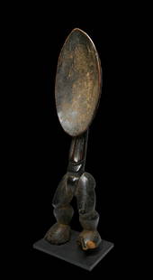 A Fine Dan Wakemia Spoon Ex Nooter: A finely carved wooden ovoid ladle atop torso, no arms, well-developed legs. Very good, with fine original patina, wood losses to feet. Artists in Dan communities of Liberia and Cote d'Ivoire have mas