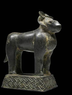 Benin Bronze Ram Ex Kahan Gallery: A cast bronze aquamanile created as a lost-wax cast in brass. In form of standing ram. Hollow casting with small opening on top of head for pouring with a lid. Ram depicted with upright ears, curving