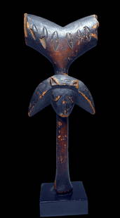 A Yoruba Shango Cult Staff: A very old and well used wooden staff with zoomorphic janus faces on either side and central Axe like form on top with scar designs. Yoruba peoples,, Shango cult, Nigeria, West Africa. The staff measu