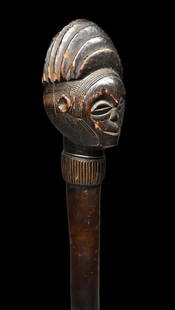 A Chokwe Scepter: A finely carved old wood staff or scepter with anthropomorphic head with a stylized coiffure, very finely incised linear designs , round ears and a deep well handled surface patina. Chokwe or Luena pe