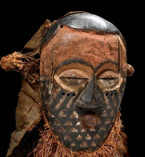 A Kuba Dance Mask Ex Xanadu Gallery: This is an old, field used ceremonial mask made from carved wood and painted. The Mask still has its original raffia grass headdress and was embellished with wonderful painted geometric designs in a c