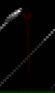 A Well Used Old Zulu Club or Knobkerrie: A fine carved club or knobkerrie of a dark hardwood, with an oval shaped solid spherical head. The shaft is embellished with a segment of finely plaited copper and brass wire. Such weapons were