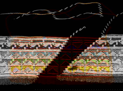 A Zulu Beaded Skirt Panel: A Long well made beaded skirt panel with fine beadwork designs and embellished with copper chains. The Sash or belt measures 12 x 6 inches. Provenance: Ex Charles Bordogna Collection, Author and past