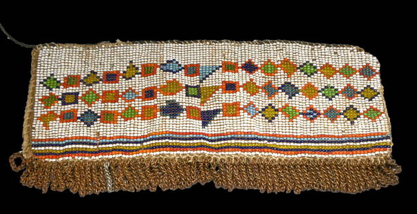 Antique Zulu Beaded Skirt: A Long well made beaded skirt panel with fine beadwork designs and embellished with copper chains. The Sash or belt measures 10 x 4 inches. Provenance: Ex Charles Bordogna Collection, Author and past
