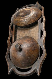 A Fine Serving Tray from The Lozi: A carved wooden serving tray with two lidded dishes and a wonderfully stylized form to the tray which measures 22 x 12 inches. Two dishes with fitted lids, both showing significant field use and