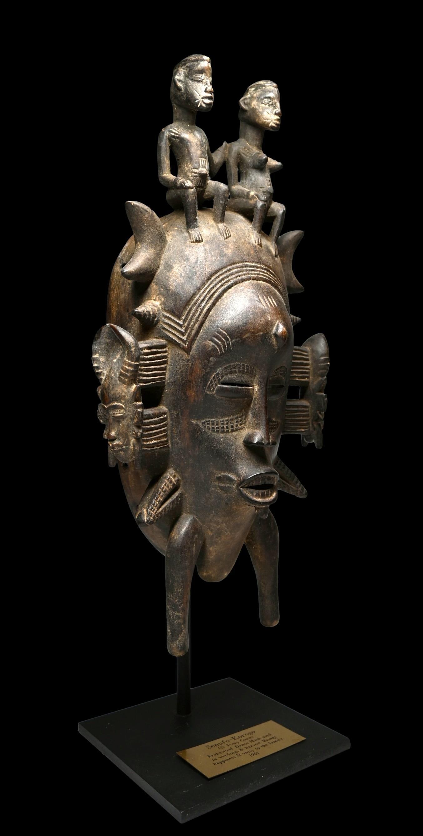 A Senufo Kpelie African Mask: A mid 20th century carved wooden Senufo Kpelie Mask with traditional style face and horns, Mali / Ivory Coast, West Africa. The kpelie mask is used by men’s societies for the initiation of boys into