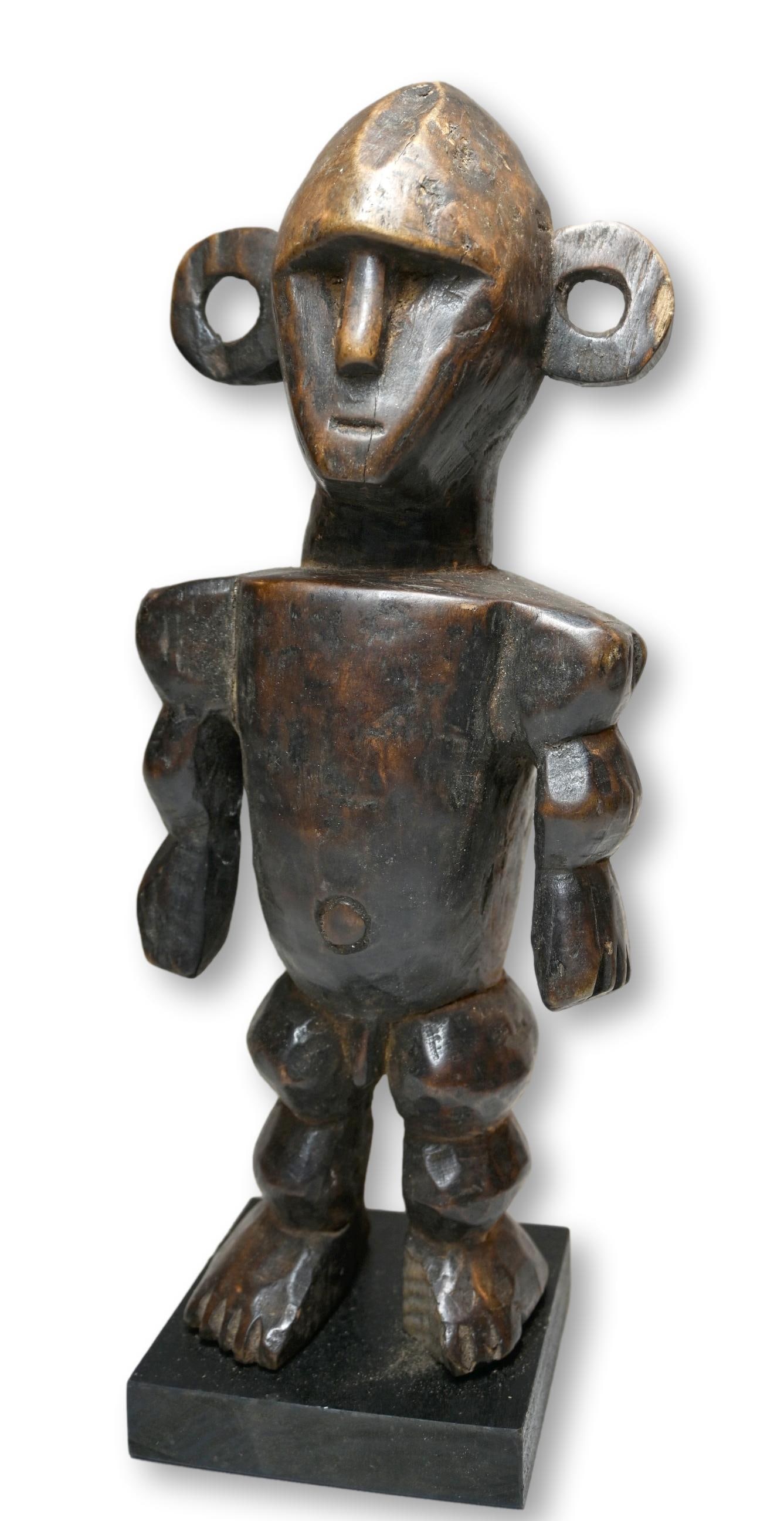 A Boa Sculpture, African Art: A carved wooden sculpture in the style of the Boa Peoples, Congo, Africa. The figure measures 12 x 4.5 inches and has been custom mounted for display.