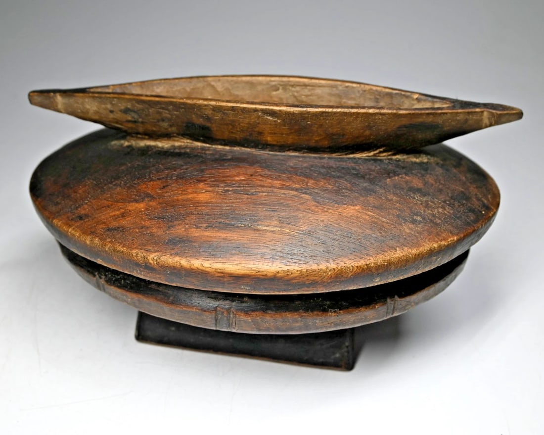 Old Lozi Container with Boat shaped Handle: A very well handled and worn carved wooden vessel with fitted lid, this is a older vessel that has a traditional main bowl and a lid that features a canoe or boat as a handle. The Bowl measures 9.5 in