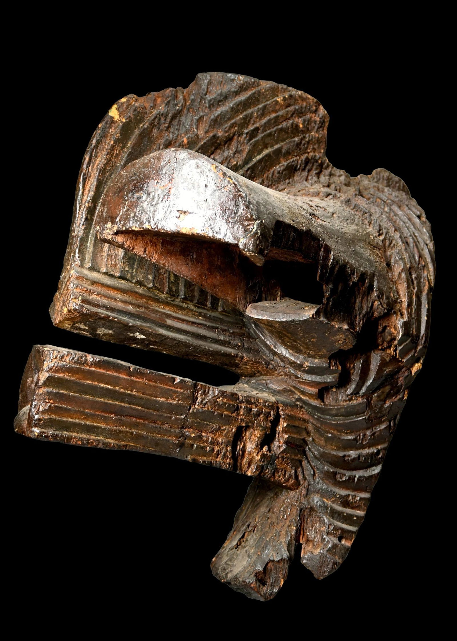 A Songye Kifwebe Society Mask: A highly stylized carved wooden ceremonial mask decorated with incised linear bands, painted on with mineral pigments. This is a rare old field used example of a male kifwebe society mask was most lik