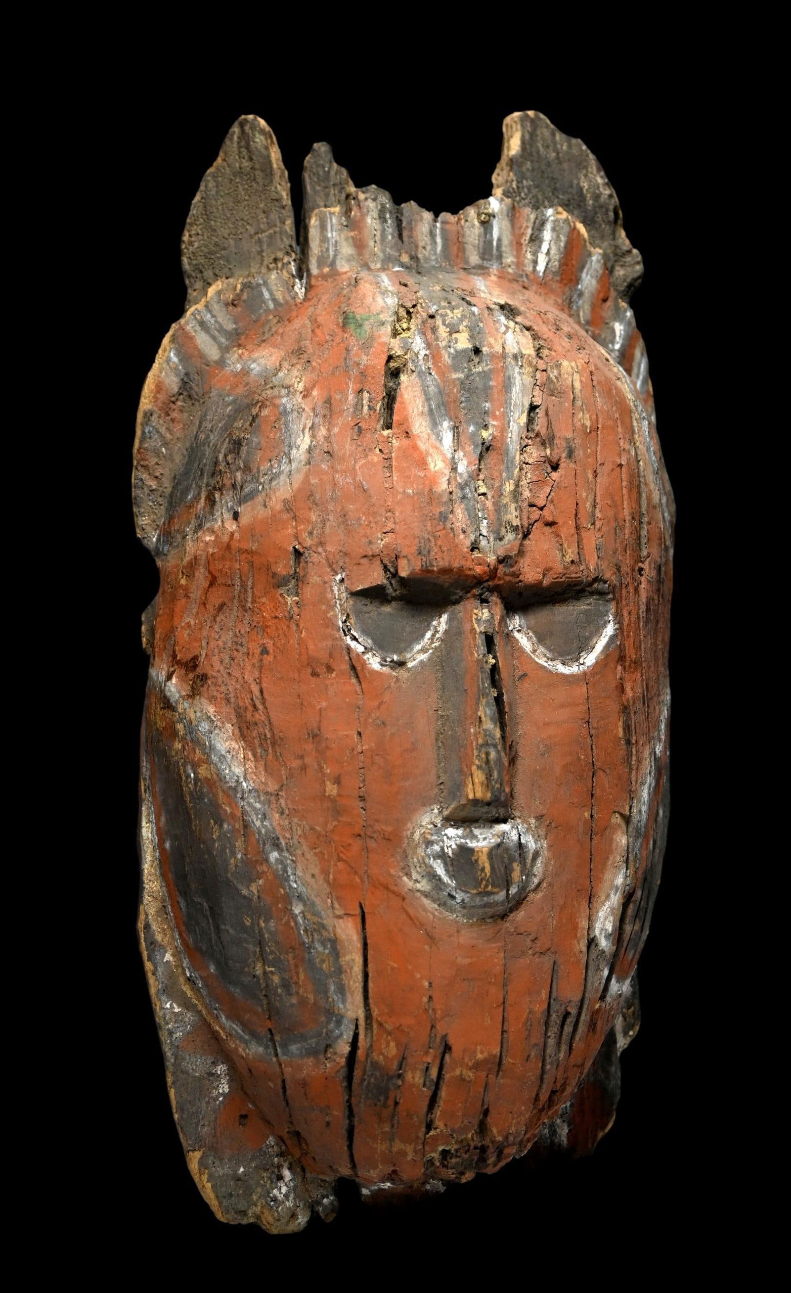 Archaic Abelam Mask Fragment: An Abelam carving, Abelam people, Maprik hills, East Sepik province, Papua New Guinea.This mask like face was likely part of a much larger sculpture or post, however it is now fragmented and eroded an