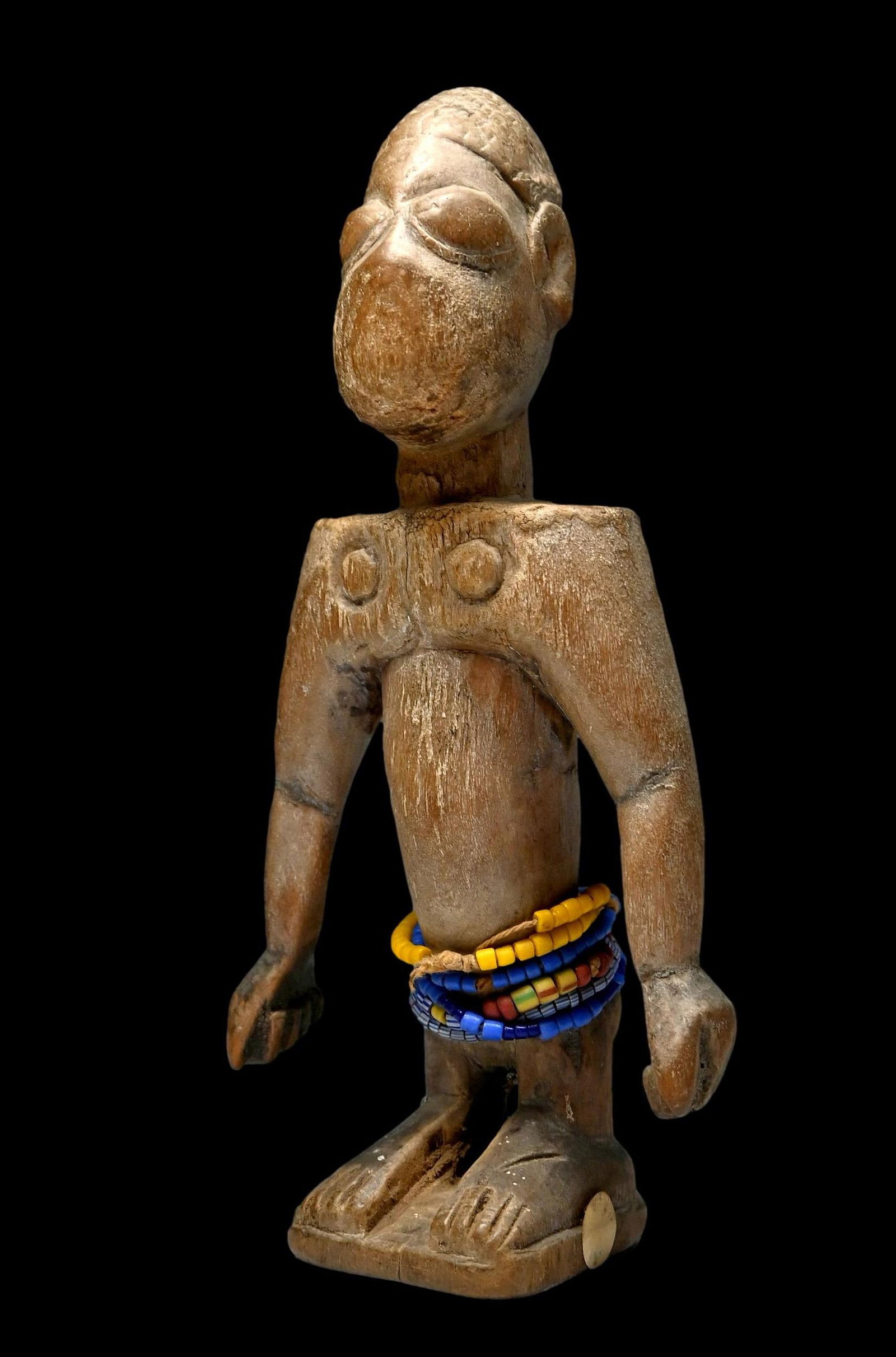 Ewe Venavi Twin Idol: A carved wooden female sculpture representing a deceased twin and carved for in rituals by the surviving twin to honor the dead, for protection, and also serving as fertility charms for women. These f