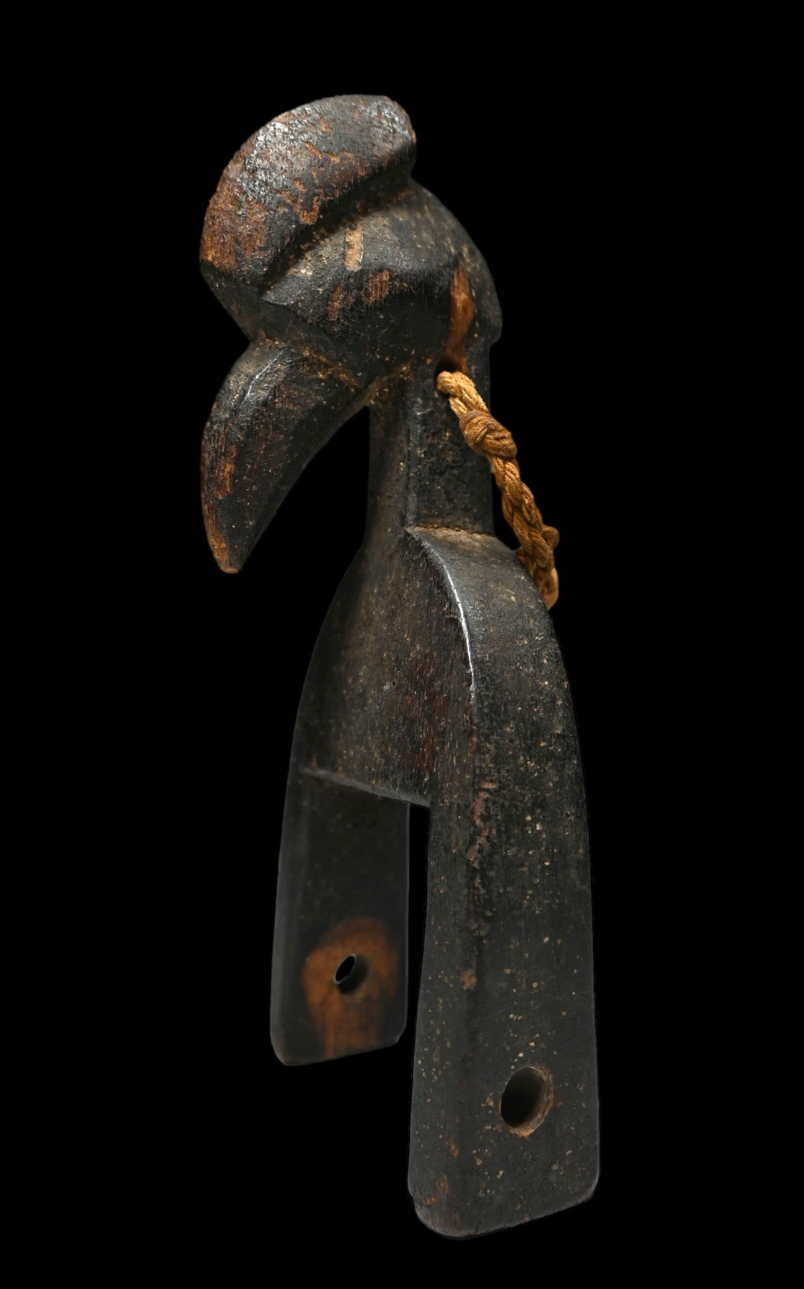 A Senufo Heddle Pulley: A finely carved old weaving heddle pulley with Hornbill bird motif. Senufo peoples, Ivory Coast, West Africa. The Pulley is well used and measures 7 x 3 inches. Provenance: Ex Karl Stirner collection,