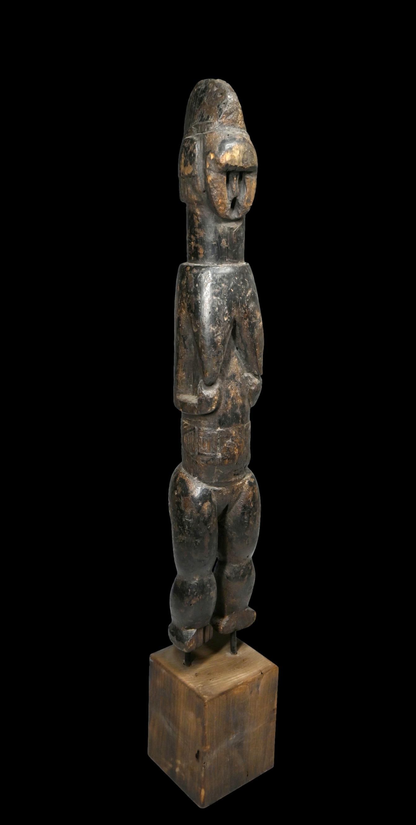 A Bete Female Sculpture: A tall carved wooden female effigy with haunting face and well handled and worn surface. Bete peoples or related ethnic group, Liberia, West Africa. The sculpture measures 21 inches tall, 27 inches ta