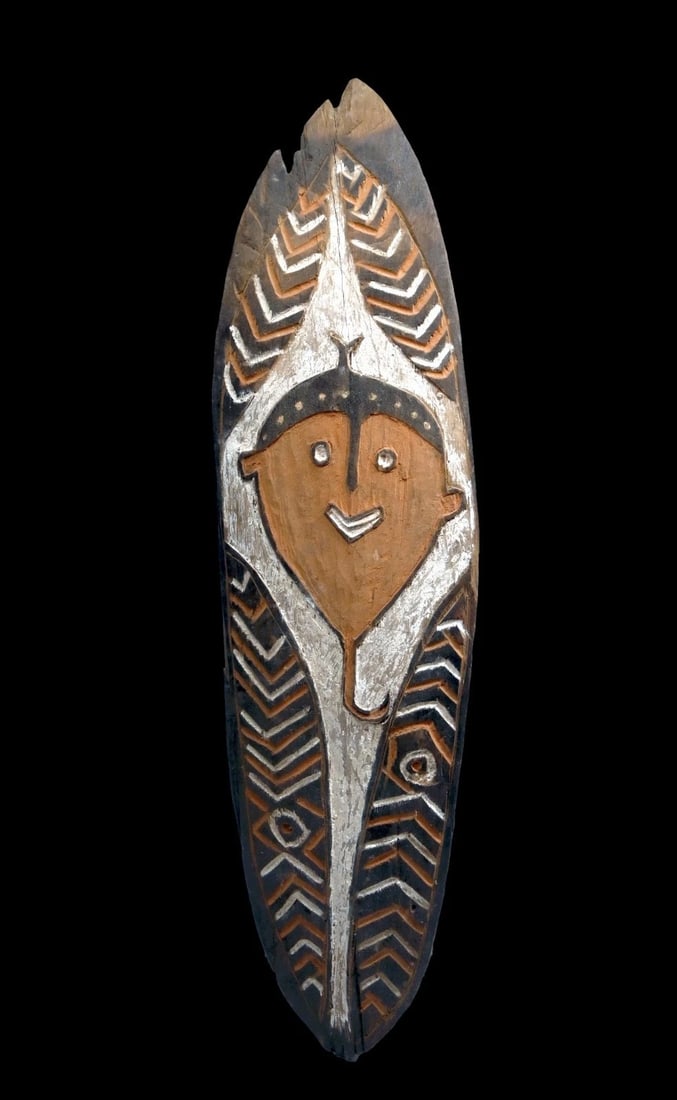 Old Gope or Spirit Board from New Guinea: A spirit board (Gope), Gulf province Papua New Guinea.A classic example with central stylized face surrounded by spiral motifs.Spirit boards of the Papuan Gulf were traditionally made in the Central