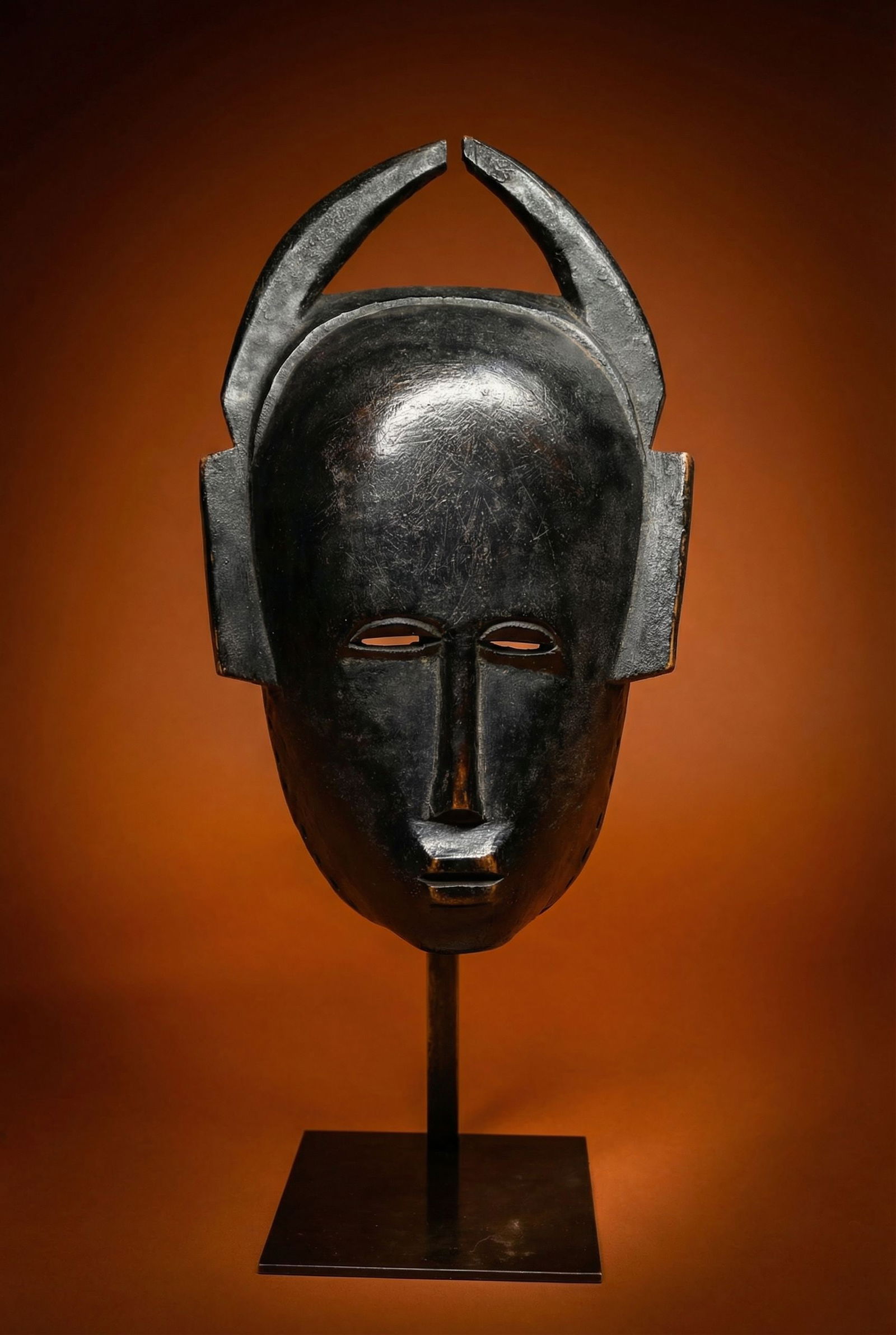 A Senufo Mask Ex Olivier Castellano: A finely carved wooden ceremonial mask with well handled glossy patina , stylized animal horns and traditional flared accents on the sides of the mask face. Senufo peoples, Ivory Coast, West Africa. T