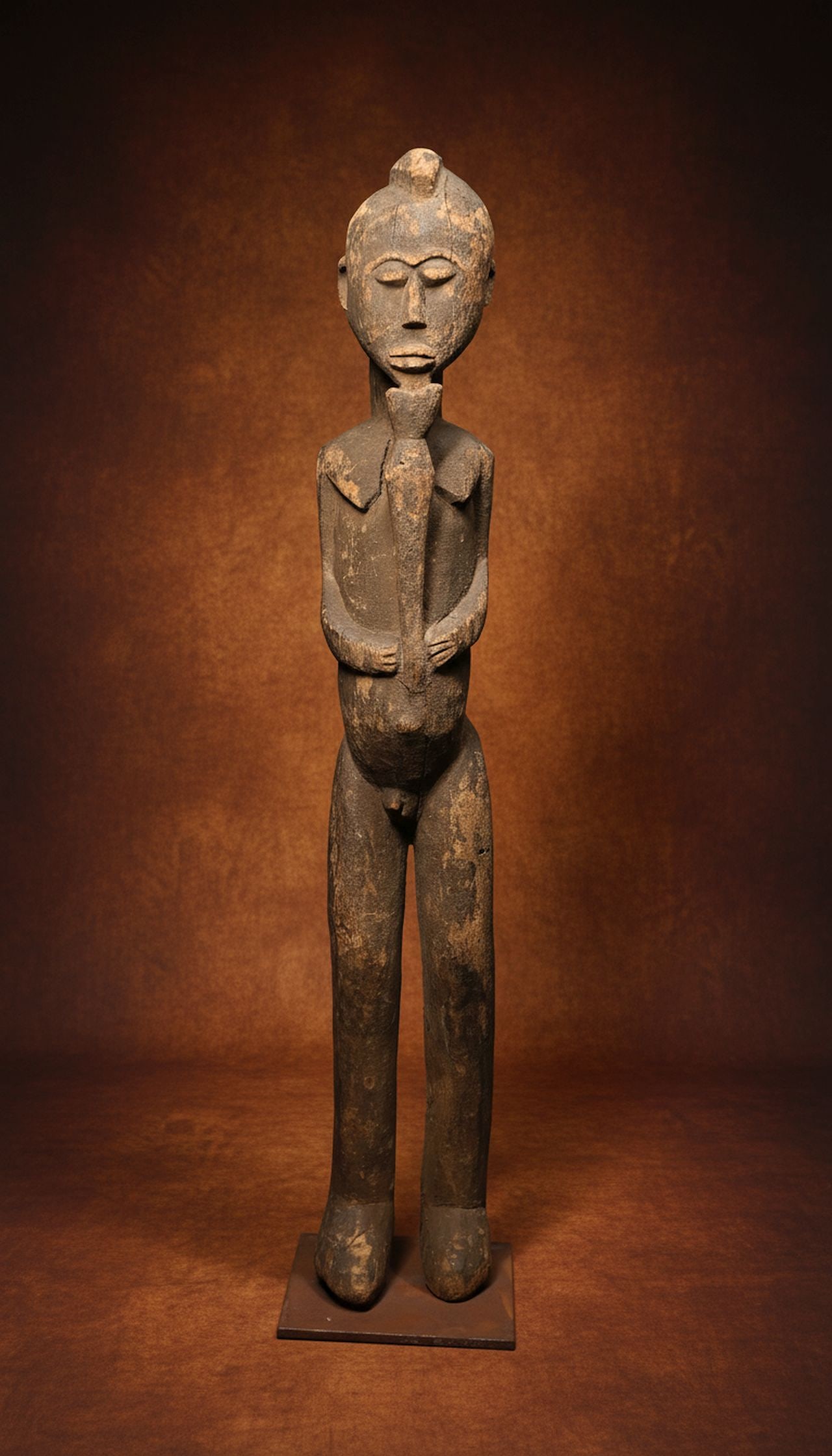 A Lobi Flute Player Sculpture Ex Thomas Wheelock: A lovely carved wooden male effigy with stylized facial features and form, well handled surface patina and shown playing a flute. The sculpture measures 30.5 inches tall x 4.5 inches wide on professio