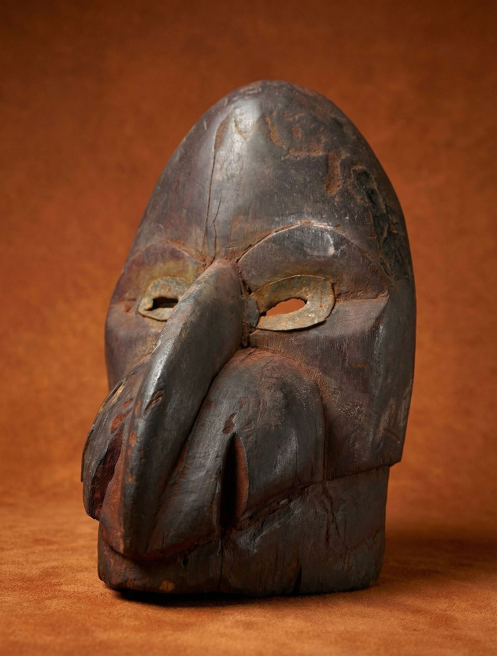 Old Dan Gagon mask collected in the 1960s: A carved wooden mask with avian style beak and weathered surface. This is likely only part of the Gagon mask, the lower jaw has been lost before collected. The mask measures 8.5 x 5 inches. Dan people