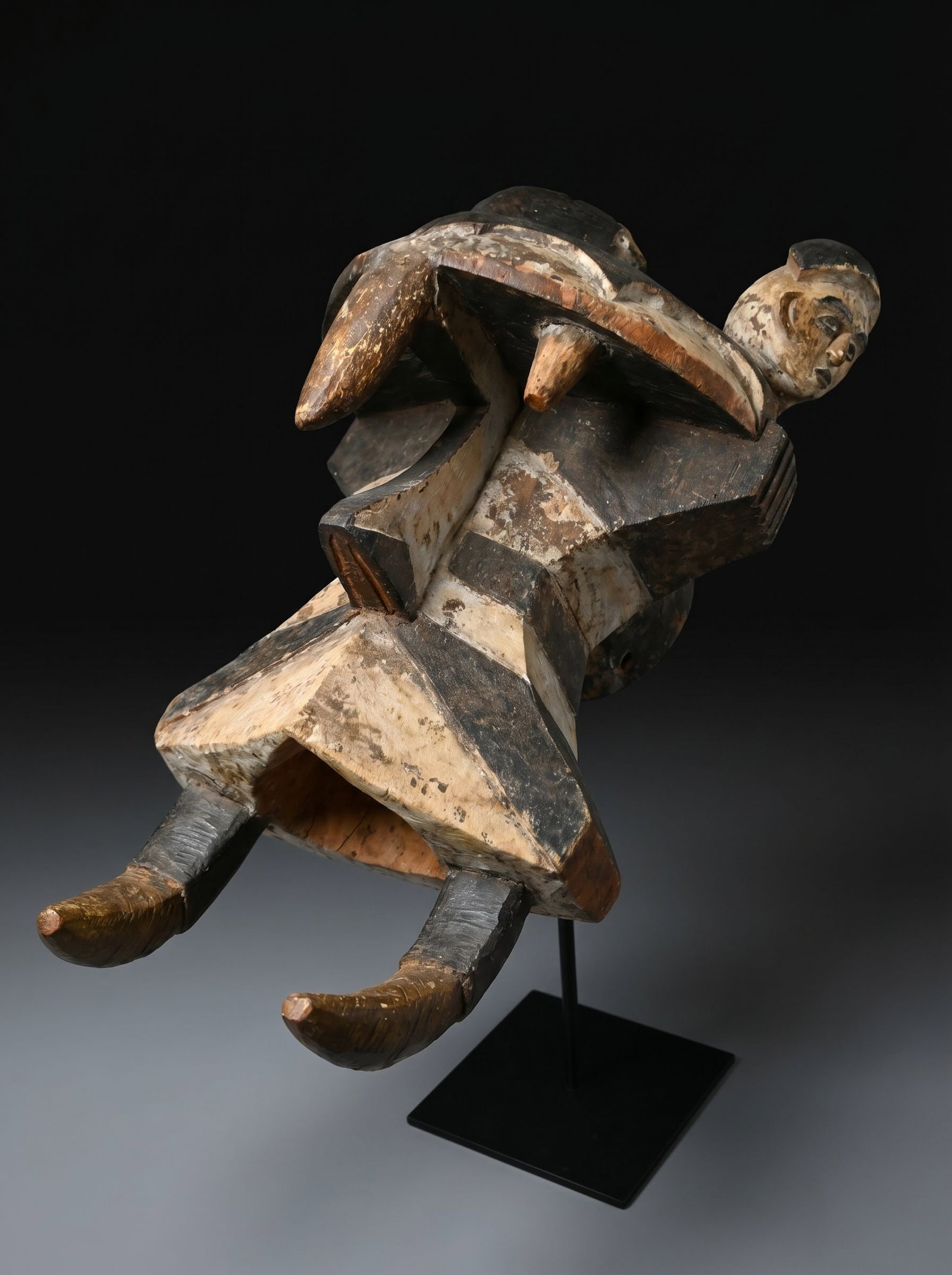 A Igbo Izzi Elephant Spirit Mask: A carved wooden helmet style mask with ornate incised, raised and painted designs, as well as two mask like faces on the top, mineral pigments. known as Ogbodo Enyi or spirit of the elephant, this is 