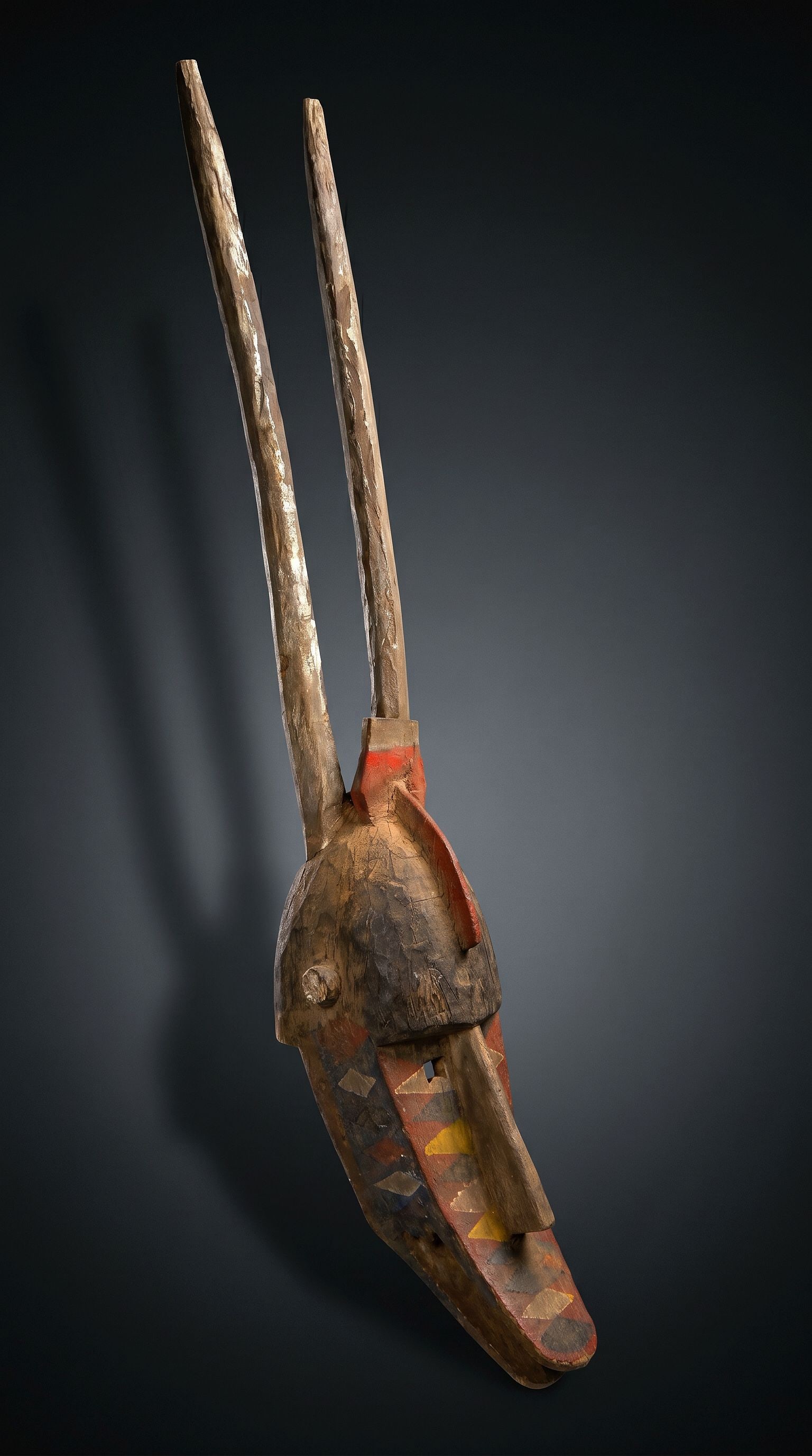 A Large Bobo Zoomorphic Mask: A large carved wood and painted mask with zoomorphic features, likely representing and antelope or other. The mask measures an impressive 56 inches tall x 10 inches wide. Bobo peoples, Burkina Faso, W