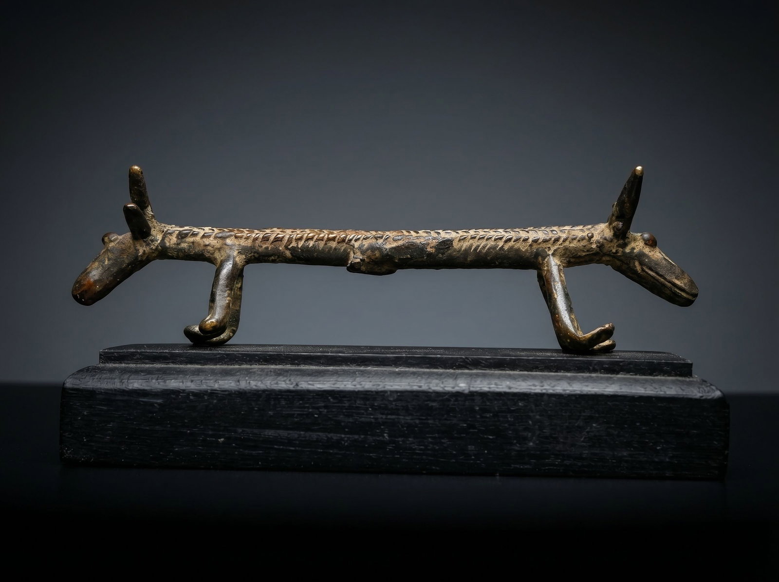 A Bwa Divination Sculpture Ex Knopfelmacher: A most unusual bronze zoomorphic divination figure from Burkina Faso, Bwa peoples, depicting a two-headed quadruped with slender, elongated body with incised markings. Facial features include long sno