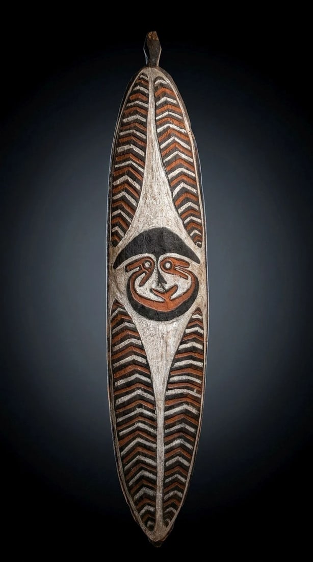 Large Kikori peoples Spirit Board: A Kikori area spirit board (Gope), Gulf province Papua New Guinea. (C. 20th Century).The board was carved in classical style for the type, featuring a wonderfully stylized face with typical avian feat