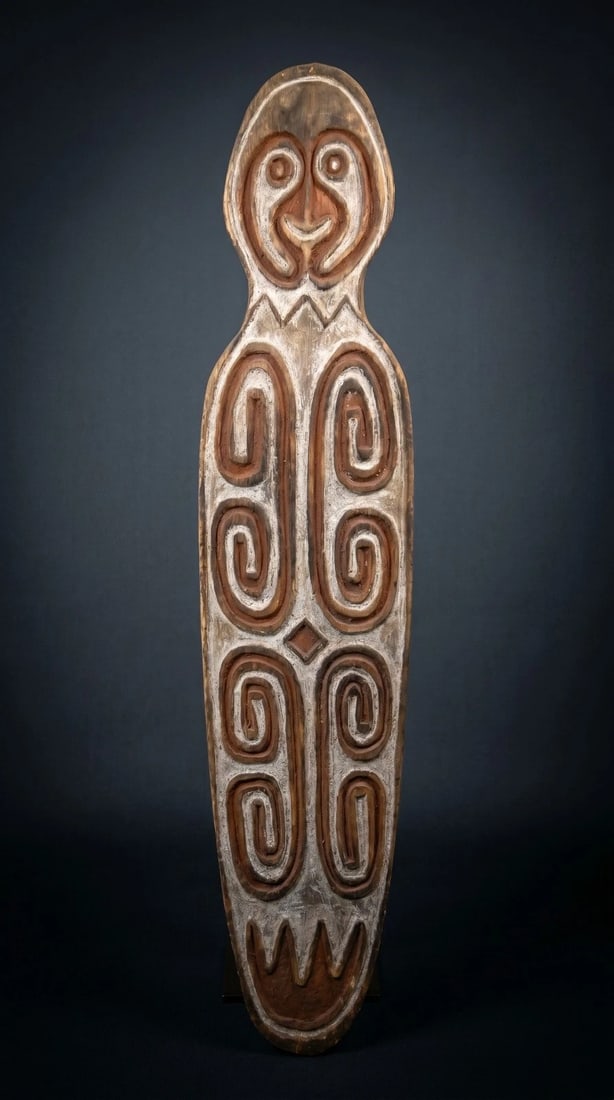 A Era peoples Spirit Board: A Era or Purari peoples spirit board (Gope), Gulf province Papua New Guinea. (C. 20th Century).This carved wooden board of classical style for the region, with central stylized face surrounded by
