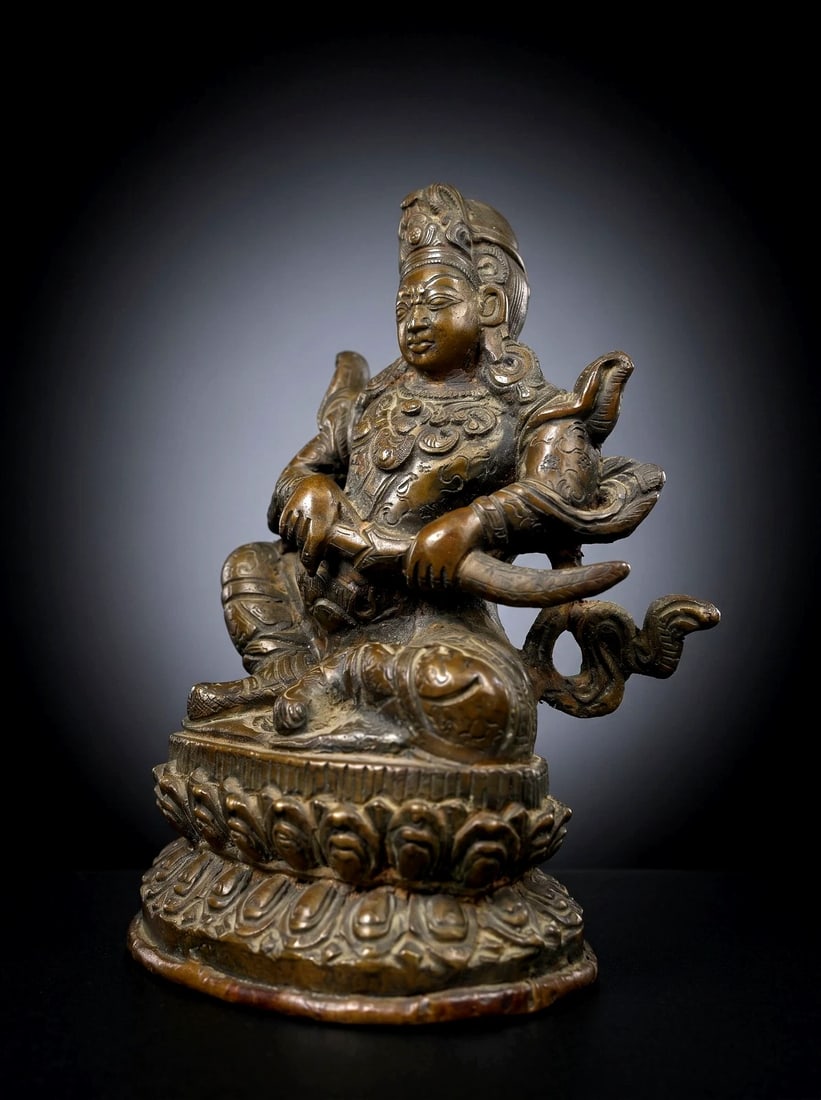Antique Qing Dynasty Immortal Bronze Sculpture: A very finely crafted antique bronze Immortal or possibly a Provincial Manhuahri sculpture from China. The sculpture features a finely crafted deity withdrawing his sword from the scabbard. This