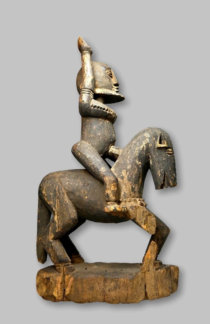 Ancient Dogon Equestrian Sculpture Ex Pearson Collection: A sculpture of a equestrian / horse and rider, with a highly stylized horse, which features an elongated face, and the rider, This figure with his hand in the air may portray a hogon, the tribal leade