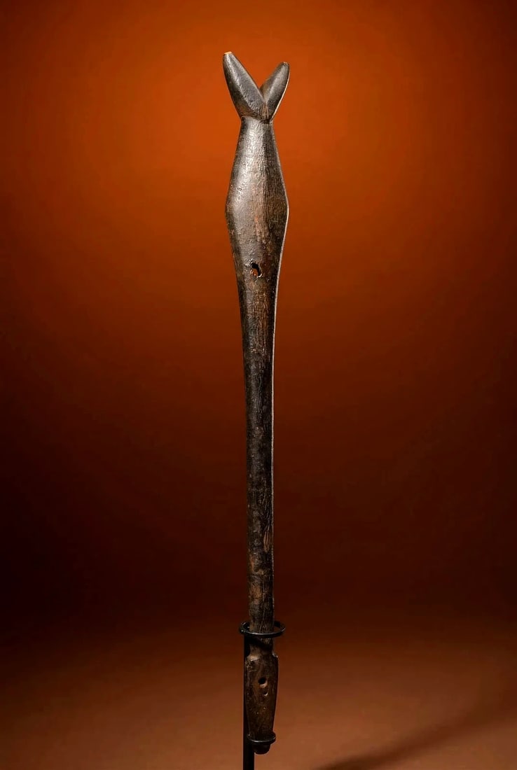 A Fine Old Bwa Flute Ex Thomas Wheelock Collection: A very finely carved wooden flute or whistle with a chevron shaped mouth piece and traditional form, pierced and some resin on one side of the hole, to change pitch, as well as an incredible deep shin