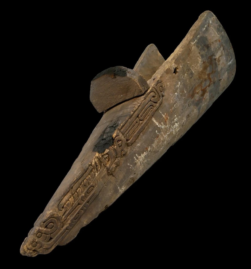 A Massim Canoe Prow Ex Rudi Ceaser Collection: A Massim Canoe prow. Milne Bay province, Papua New Guinea.Of typical form, the prow with classical Massim scroll work raised at the perimeter, with fine age. Decorated canoe prows are found virtually 