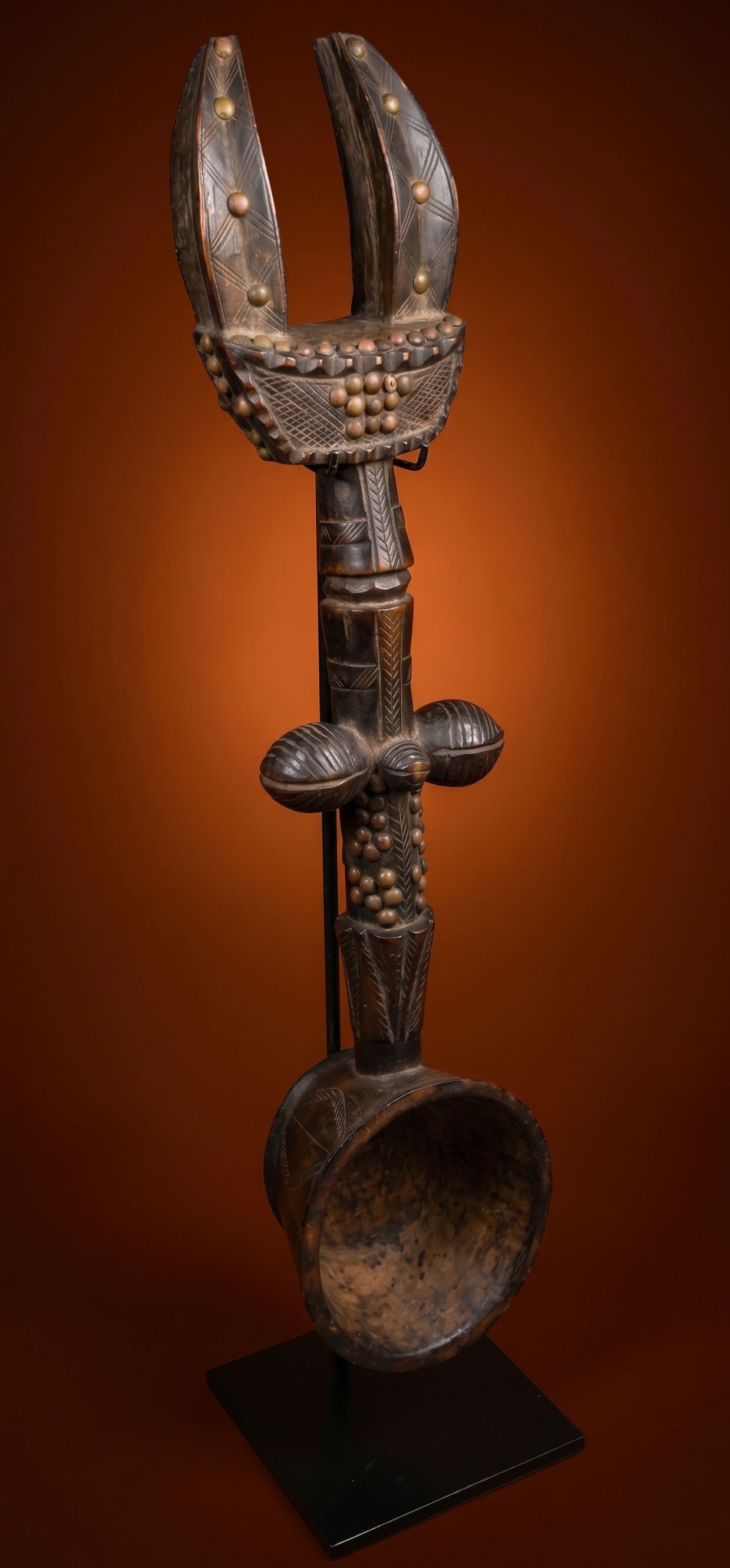 A Dan / Kran Wunkirle Feast Ladle: A elaborate carved wooden ladle or feast spoon known as a Wunkirmian by the Dan or possibly Kran ethnic group in the Ivory Coast and Liberia, West Africa. With a stylized form and embellished with met