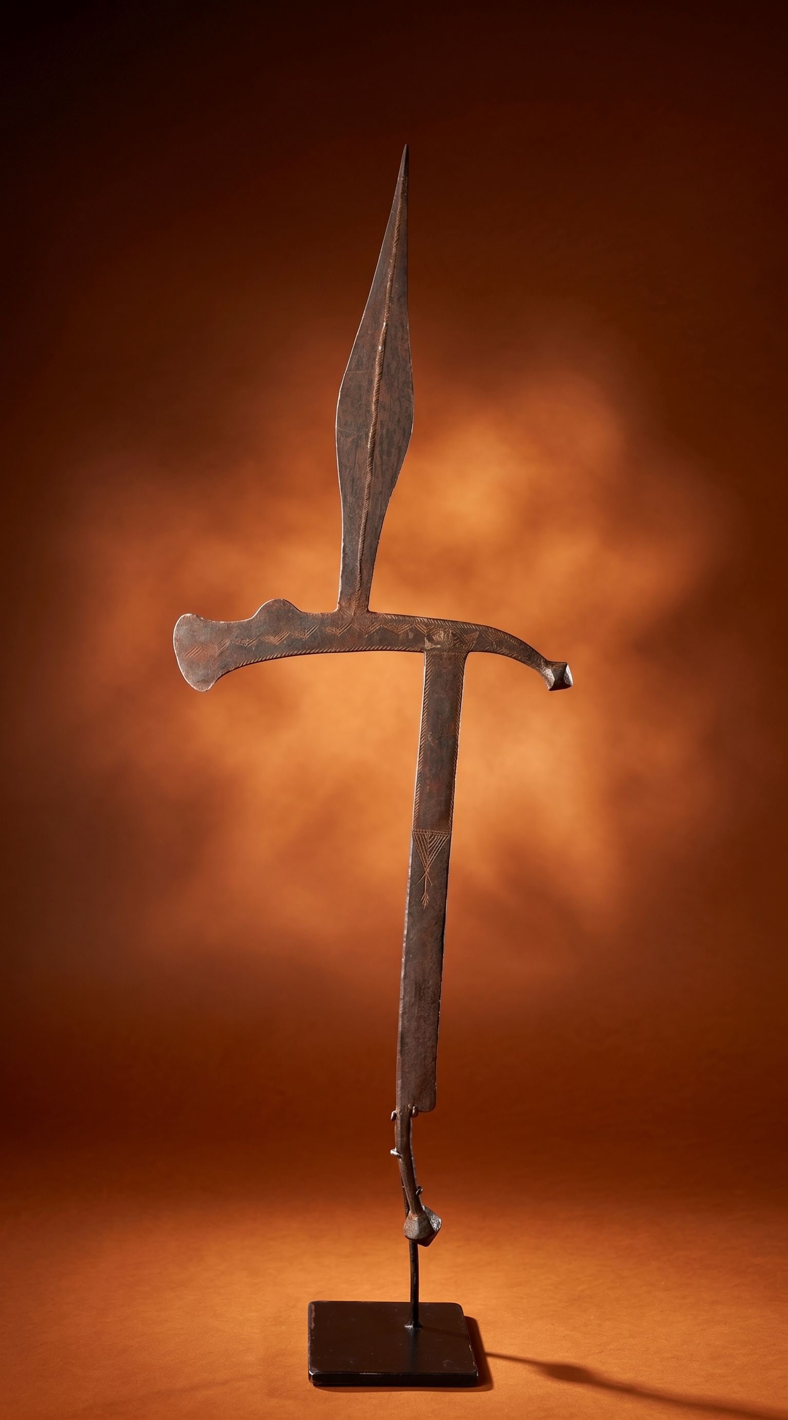 A Ga'anda Ceremonial Throwing Knife / Currency: A hand forged steel blade in traditional form with incised linear designs and signs of age and handling. Such blade served as status symbols, ritual objects, bride wealth and currency. Ga'anda peoples
