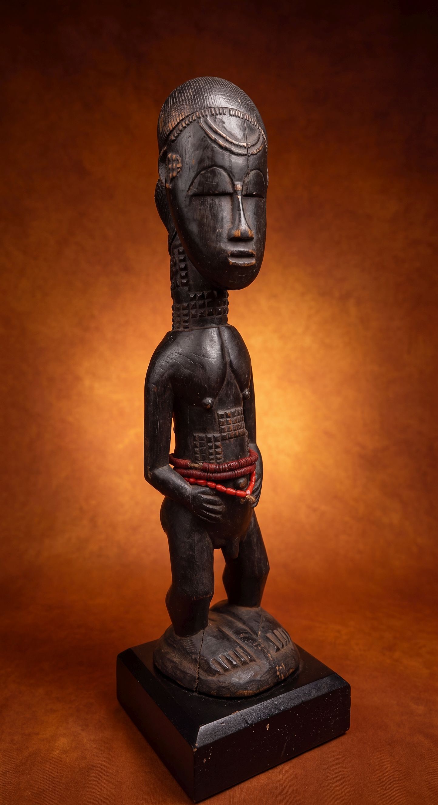 A Baule Spirit Husband, African Art: A carved wooden male shrine sculpture from Côte d'Ivoire, West Africa that represents a blolo bian, or an otherworldly spirit husband. These carved wooden figures are adorned with glass beads and cra