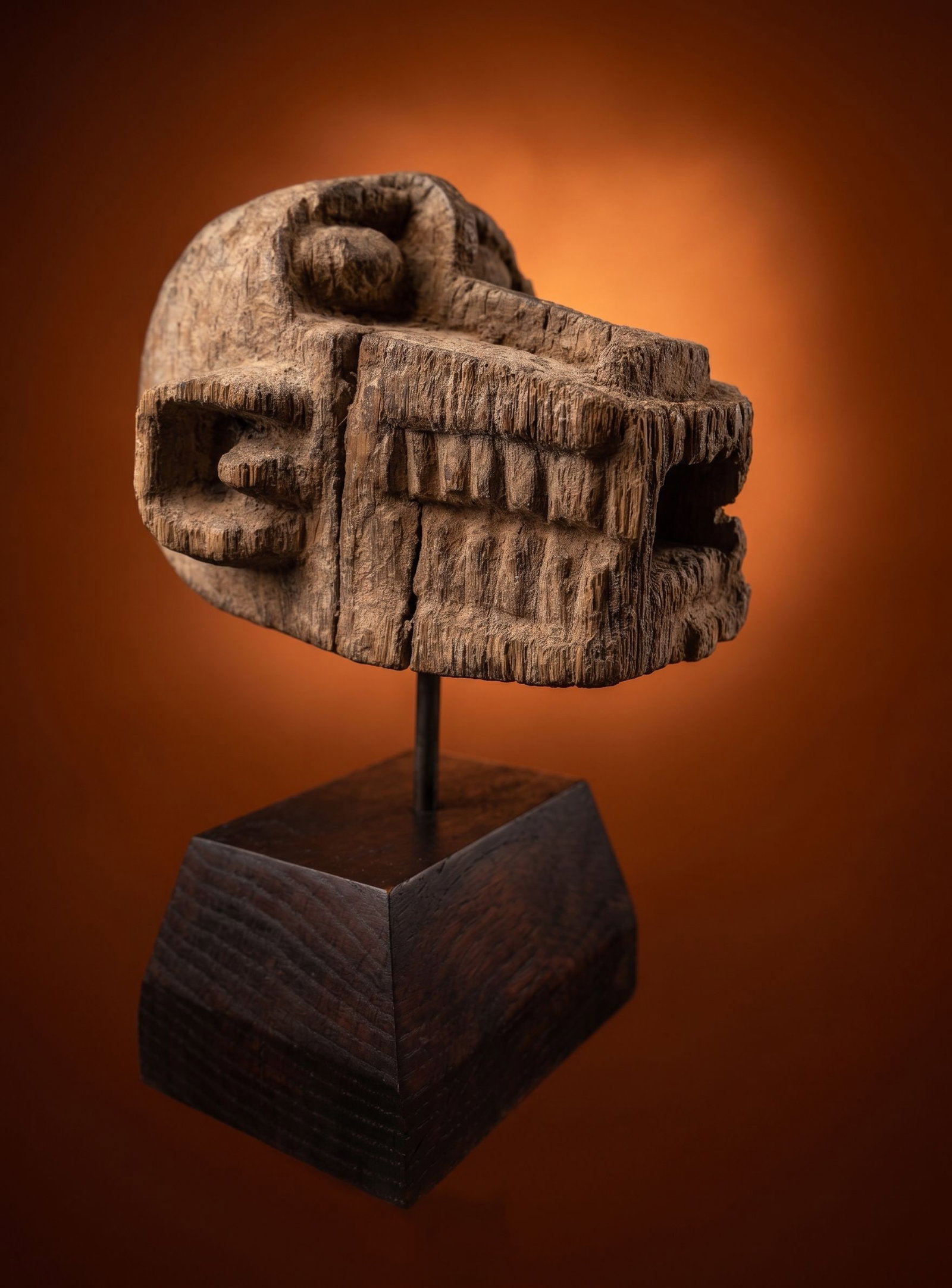 A Baule Monkey Head Shrine Sculpture: A carved wooden head of a monkey, perhaps part of a shrine used for ritual. Baule peoples, Ivory Coast, West Africa,. The sculpture measures 8 x 5.25 inches on a custom display stand.