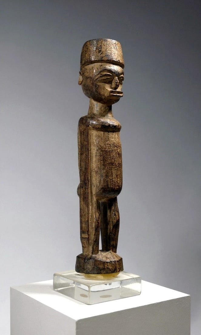 A Lobi Sculpture Ex Gansler Collection: This is a old and field used Shrine idol from the Lobi peoples of Burkina Faso, West Africa. Carved from a dense wood with highly stylized face and form, classic facial features, extra elongated arms 