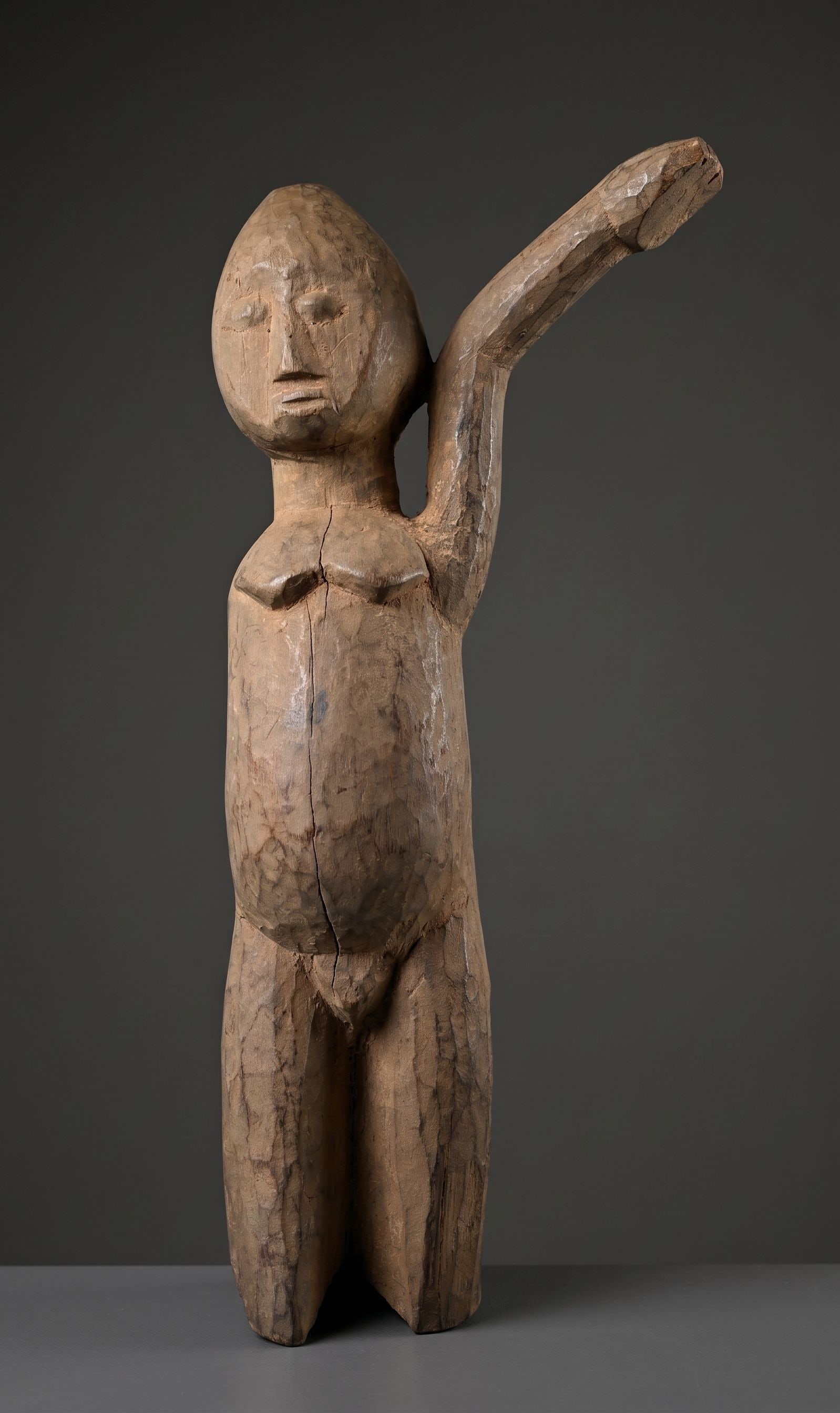 A Lobi Shrine Sculpture: A carved wooden male effigy of a Bateba Thil, a protective talisman, with one arm, the left arm extended which is considered protection from witchcraft among the locals. The sculpture measures 16 inch