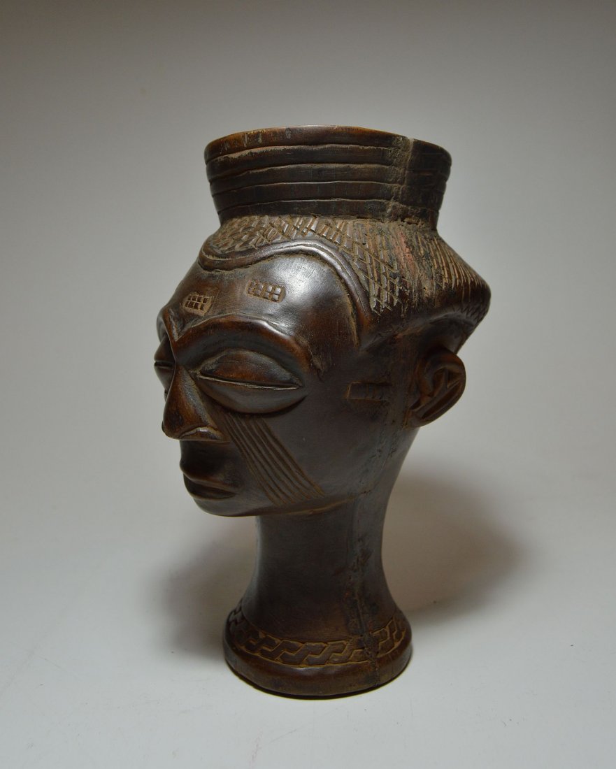 A Fine Kuba Palm wine cup w/ ancestor face, African Art: Elegant carved wooden cup used in ceremonial drinking of palm wine. Kuba peoples, DRC / Congo, Africa. Measures 7.5 x 5.5 inches