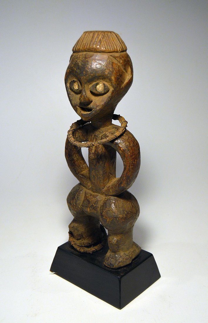 Rare Azande Female idol, African Tribal Art: This is a very fine and vintage Ancestor sculpture from the Azande peoples, DRC / Congo central Africa. Carved from a single piece of wood with a well handled and weathered surface patina, adorned wit